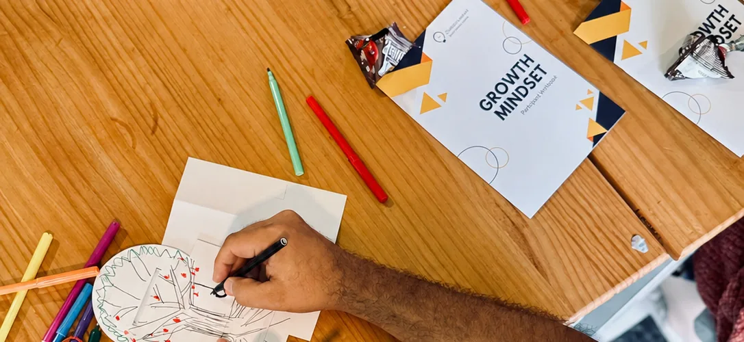 Participant completing a Growth Mindset activity during an Overpowered workshop